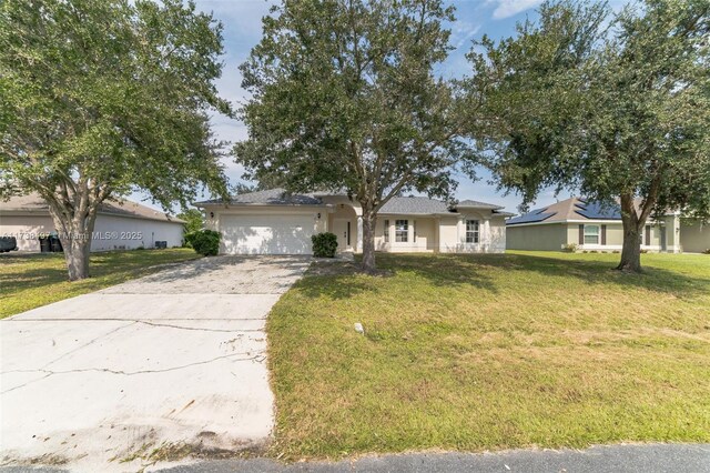 single story home featuring a garage and a front lawn