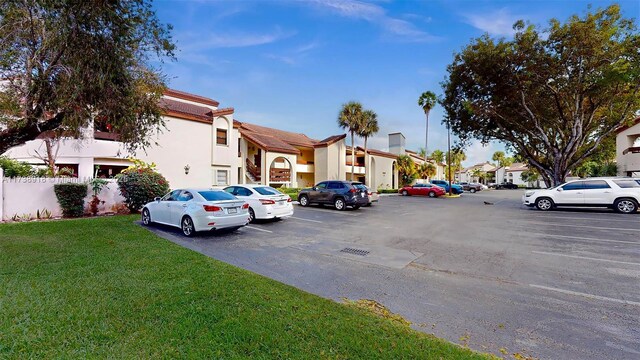 view of vehicle parking with a yard