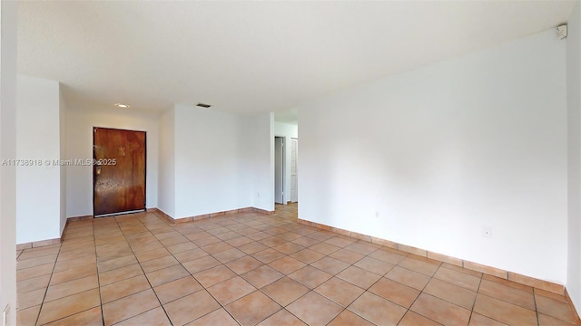 empty room with light tile patterned floors