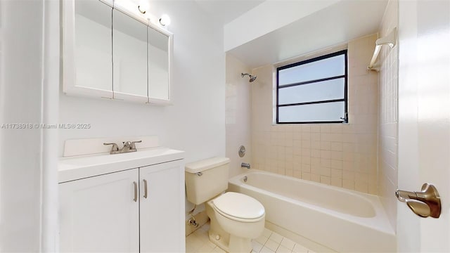 full bathroom featuring vanity, toilet, tiled shower / bath combo, and tile patterned flooring