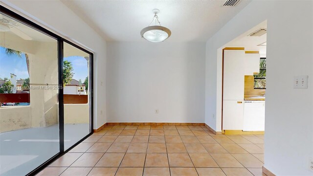 tiled empty room with a wealth of natural light