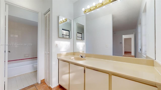 bathroom featuring vanity, tile patterned floors, and toilet