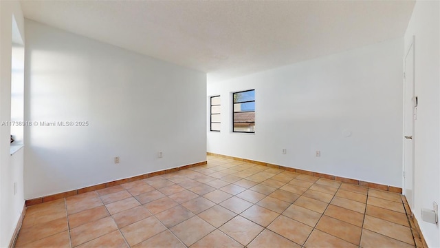 empty room featuring light tile patterned floors