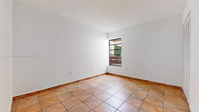 unfurnished bedroom with light tile patterned floors and a textured ceiling