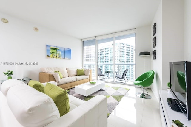 living area with tile patterned floors and floor to ceiling windows