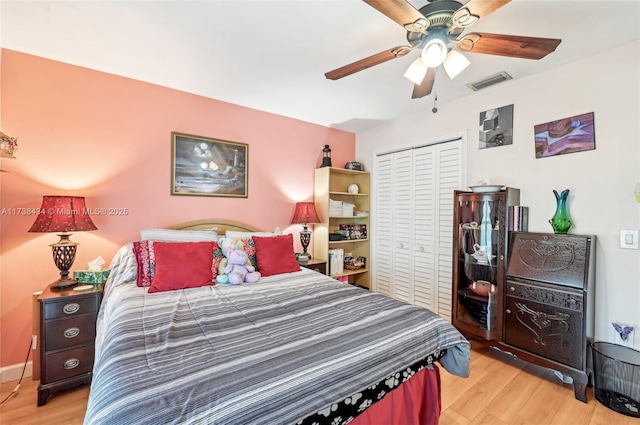 bedroom featuring ceiling fan, a closet, and light wood-type flooring