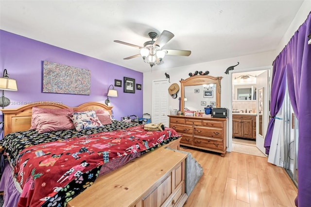 bedroom with ceiling fan, ensuite bathroom, light hardwood / wood-style floors, and a closet