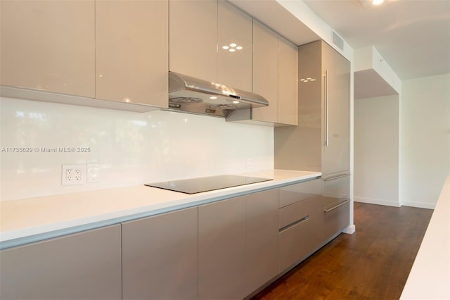 kitchen featuring black electric stovetop and dark hardwood / wood-style floors