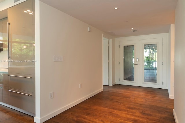 hallway with dark hardwood / wood-style floors and french doors