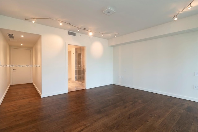 spare room with dark hardwood / wood-style floors