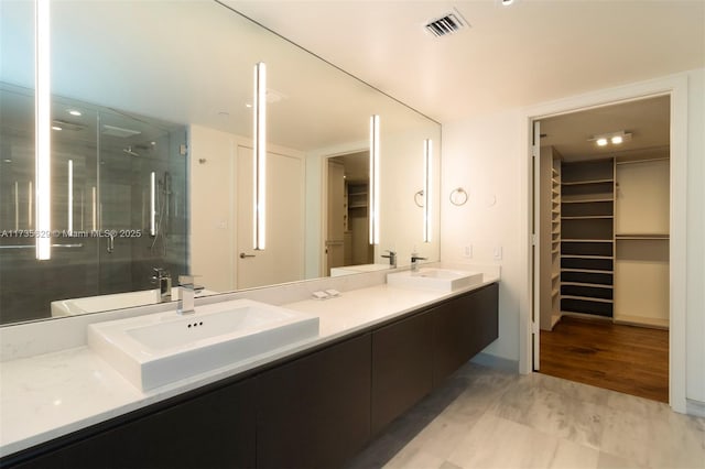 bathroom featuring vanity and an enclosed shower