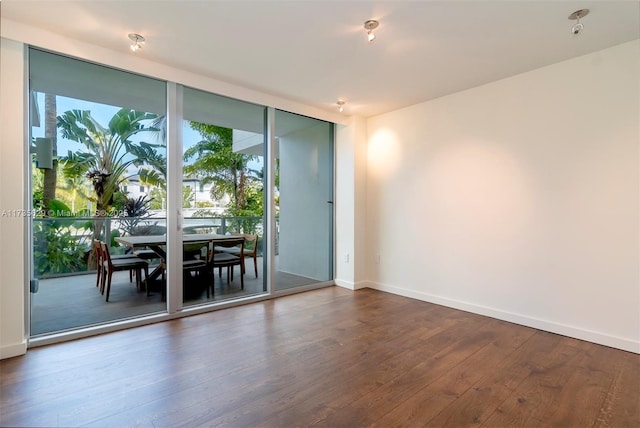 interior space with expansive windows and dark hardwood / wood-style flooring