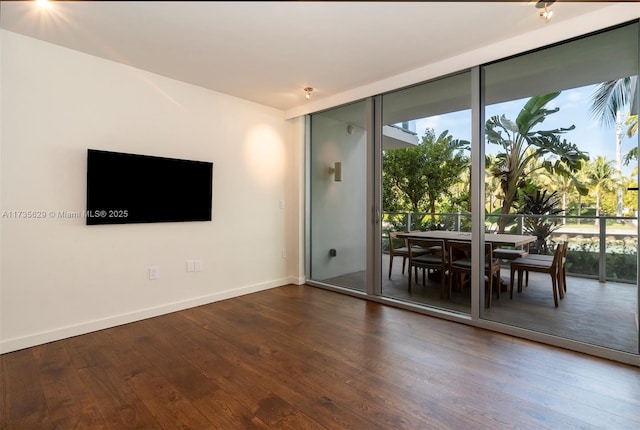 interior space featuring floor to ceiling windows and dark hardwood / wood-style floors