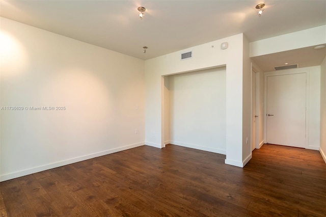 spare room with dark hardwood / wood-style flooring