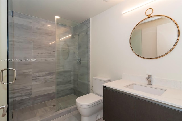 bathroom featuring vanity, toilet, and walk in shower