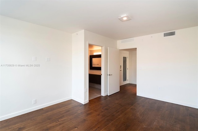 spare room featuring dark wood-type flooring