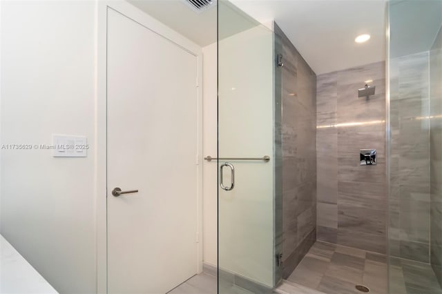 bathroom featuring a shower with door