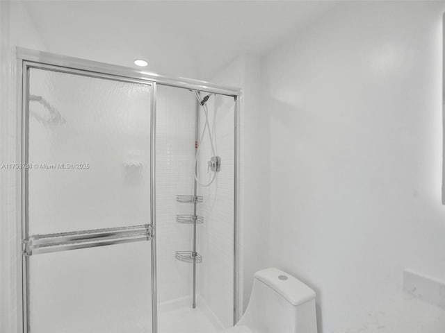 bathroom with toilet and walk in shower