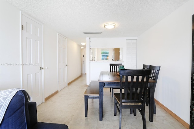 dining room with a textured ceiling