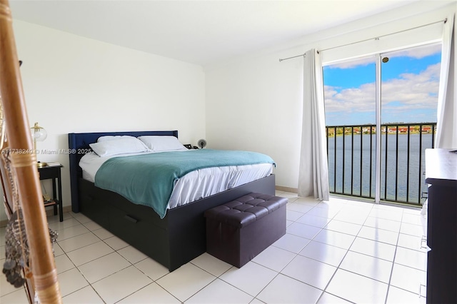 tiled bedroom featuring access to exterior and a water view