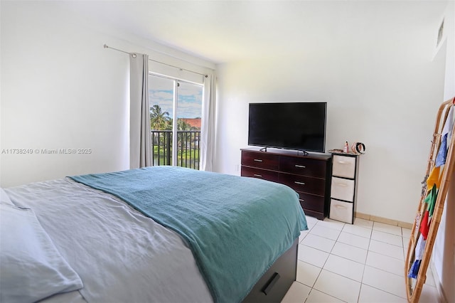 315 NW 109th Ave Unit 205, Miami, FL 33172 - bedroom with light tile patterned floors, access to exterior, and baseboards