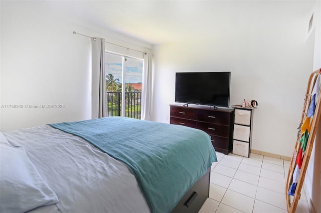 bedroom with light tile patterned floors and access to exterior