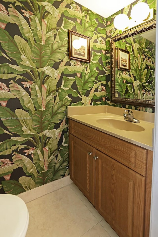 bathroom with tile patterned flooring, vanity, and toilet