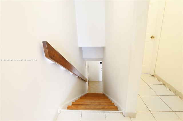 stairway with tile patterned floors