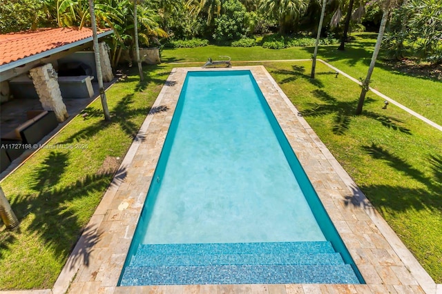 view of pool with a lawn