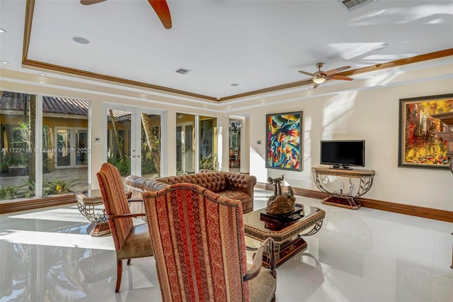 living room with french doors, a raised ceiling, ceiling fan, and crown molding