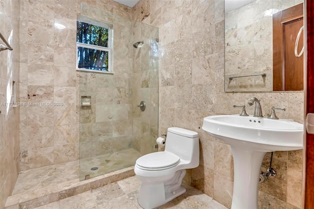 full bath featuring a sink, toilet, tile walls, and a walk in shower