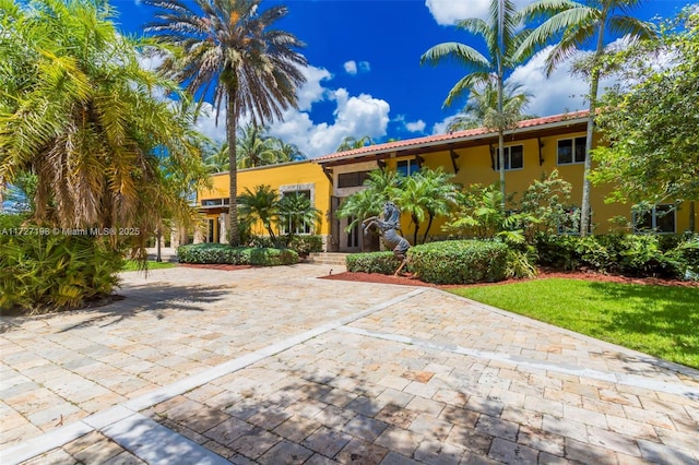 view of front of house featuring a tiled roof and stucco siding