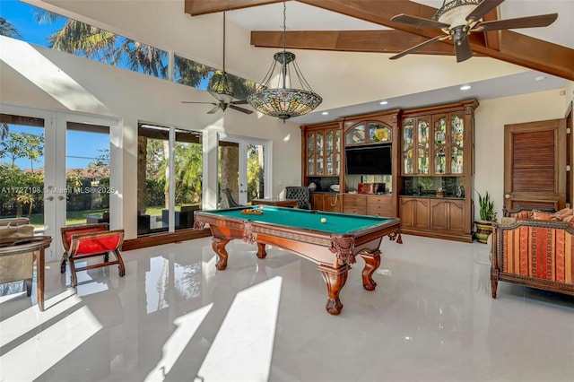 rec room with beam ceiling, a high ceiling, and french doors