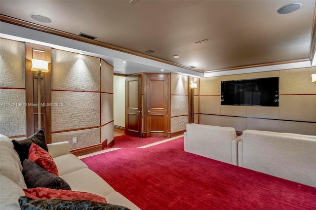 carpeted cinema with visible vents and crown molding