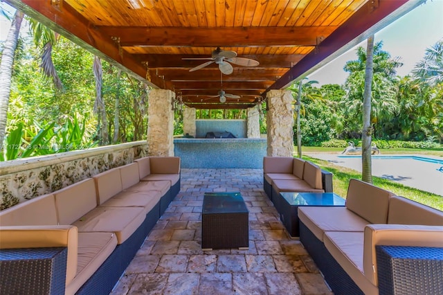 view of patio with an outdoor living space and ceiling fan