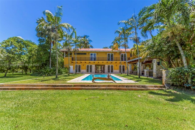 view of pool featuring a lawn and a patio area