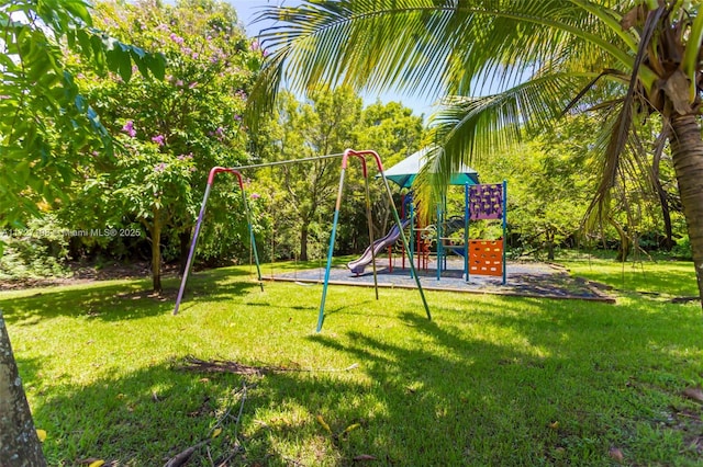 communal playground featuring a yard