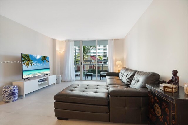 living room with light tile patterned floors and a wall of windows