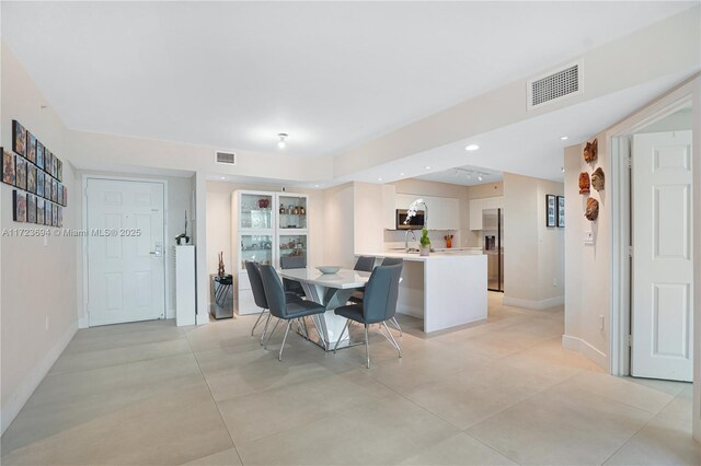 1155 Brickell Bay Dr Unit 704, Miami, FL 33131 - dining space featuring baseboards and light tile patterned flooring