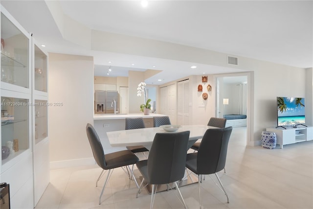 dining area with light tile patterned flooring