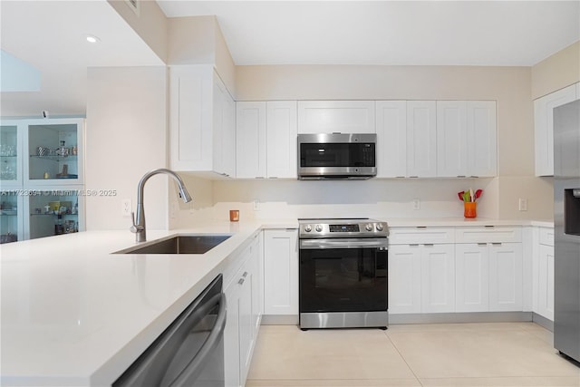 kitchen featuring white cabinetry, stainless steel appliances, and sink