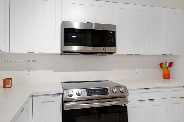 kitchen featuring appliances with stainless steel finishes and white cabinets