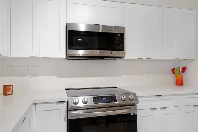 kitchen with appliances with stainless steel finishes and white cabinetry