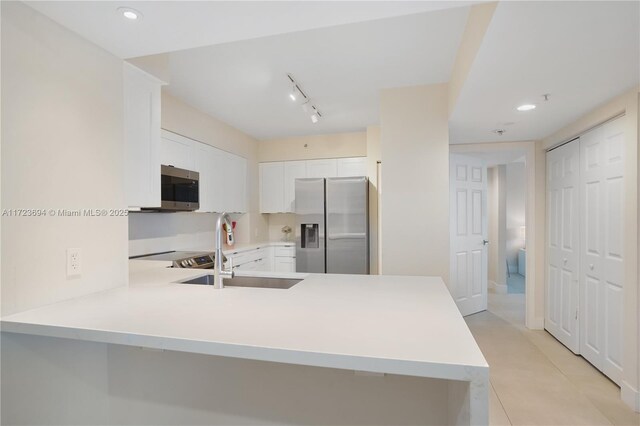 1155 Brickell Bay Dr Unit 704, Miami, FL 33131 - kitchen with appliances with stainless steel finishes, a sink, light countertops, a peninsula, and recessed lighting