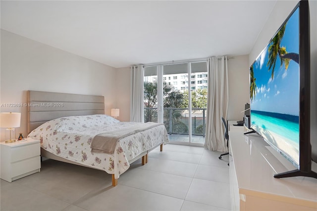 tiled bedroom featuring access to exterior and a wall of windows