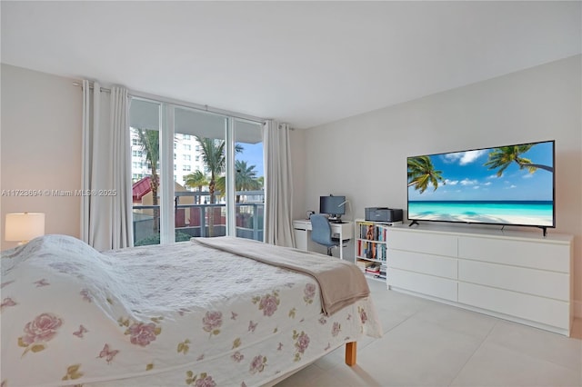 bedroom with light tile patterned floors and access to outside