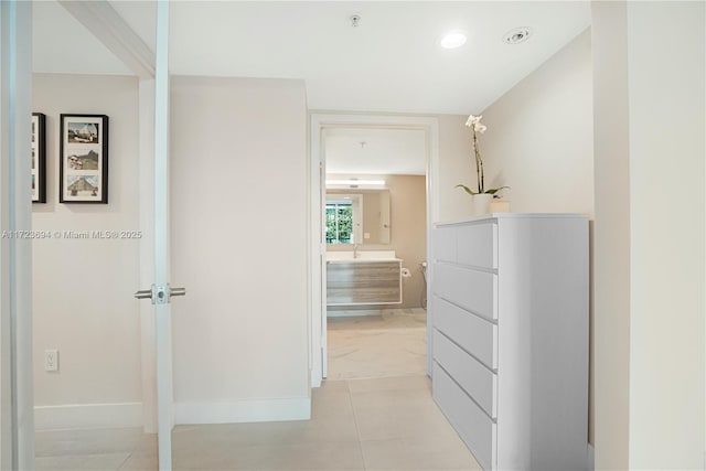 corridor featuring light tile patterned floors