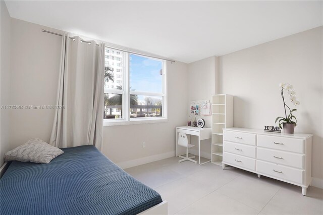 1155 Brickell Bay Dr Unit 704, Miami, FL 33131 - bedroom with light tile patterned floors and baseboards