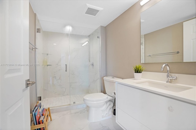 bathroom featuring a shower with door, vanity, and toilet