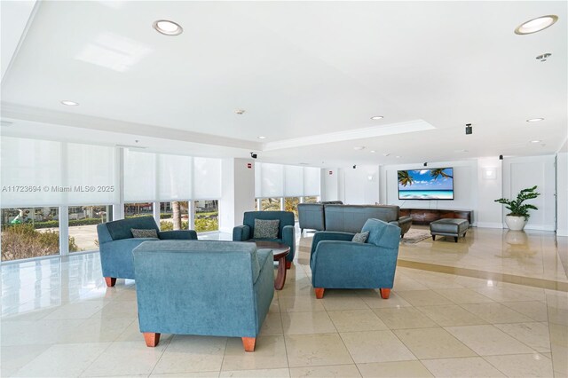 living room featuring expansive windows, crown molding, a healthy amount of sunlight, and light tile patterned floors